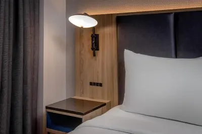a bedroom with a bed and a nightstand next to a bed sidx sidx sidx at Courtyard by Marriott Times Square West in New York