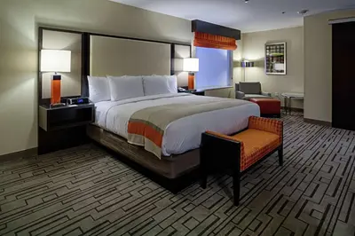 a hotel room with a large bed and a chair at DoubleTree by Hilton Hotel Bristol in Bristol