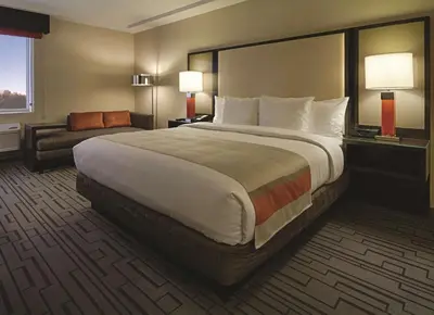 a hotel room with a large bed and a couch at DoubleTree by Hilton Hotel Bristol in Bristol