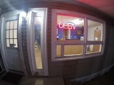 a neon open sign in the window of a restaurant at Castle Inn East Greenbush Castleton-on-hudson in East Greenbush