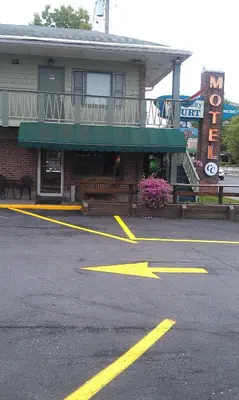 a parking lot in front of a building at Community Court Motel in Saratoga Springs