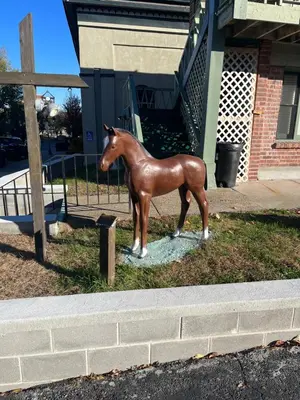 a statue of a horse on the side of a street at Community Court Motel in Saratoga Springs