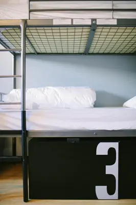 a bunk bed with the number three on it at The Local NY Hostel in Queens