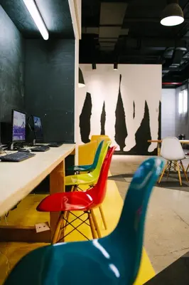 an office with colorful chairs and a desk at The Local NY Hostel in Queens