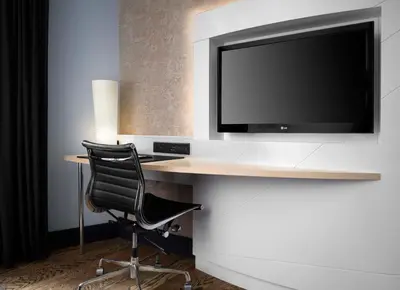 a desk with a chair and a television on a wall at Hyatt Union Square New York in New York