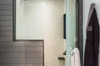 a bathroom with a shower with a glass door at Hyatt Union Square New York in New York