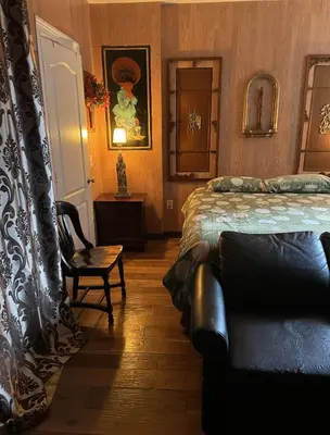 a bedroom with a bed and a couch in it at NYC Townhouse Apartment in New York