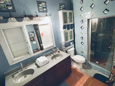 a bathroom with two sinks and a toilet at NYC Townhouse Apartment in New York