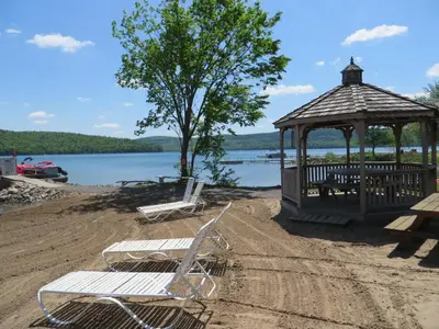 two chairs and a gazebo on a beach at Bayside Inn & Marina in Cooperstown