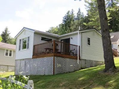 a home with a large deck on a house at Bayside Inn & Marina in Cooperstown