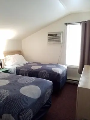 a hotel room with two beds and a window at Bayside Inn & Marina in Cooperstown