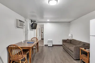 a living room with a table and a couch at Bayside Inn & Marina in Cooperstown