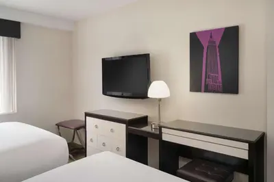 a hotel room with a bed and a tv on the wall at Best Western Premier Herald Square in New York