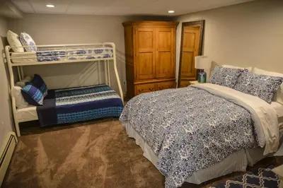 a bedroom with a bed and a bunk bed at Colgate Lake Lodge in East Jewett