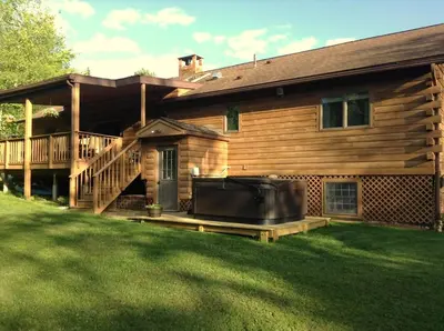 a house with a large screened in porch and a large television at Colgate Lake Lodge in East Jewett