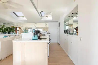 a kitchen with white cabinets and a counter top at Hudson Riverfront Home in Catskill