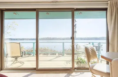a living room with a large sliding glass door at Hudson Riverfront Home in Catskill