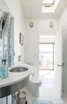 a white bathroom with a sink and a toilet at Hudson Riverfront Home in Catskill