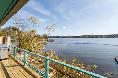 a view of the water from the porch of a house at Hudson Riverfront Home in Catskill