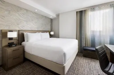 a hotel room with a large bed and a desk at Residence Inn New York Downtown Manhattan/Financial District in New York