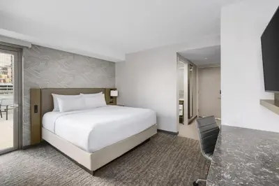a hotel room with a white bed and a television at Residence Inn New York Downtown Manhattan/Financial District in New York