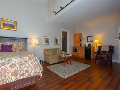 a bedroom with a bed and a living room at Shaker Mill Inn in West Stockbridge