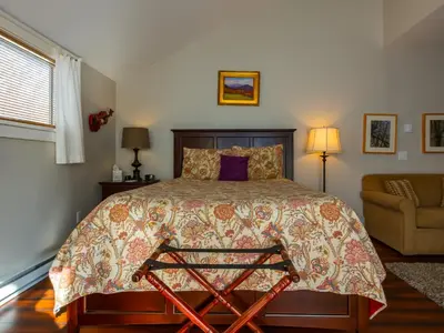 a bedroom with a large bed and a couch at Shaker Mill Inn in West Stockbridge