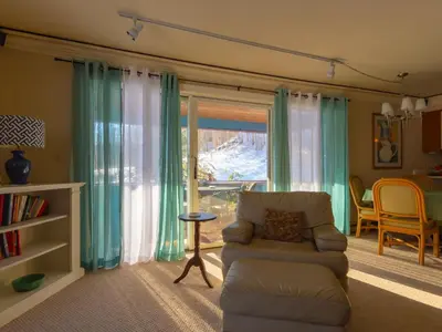 a living room with a chair and a window at Shaker Mill Inn in West Stockbridge