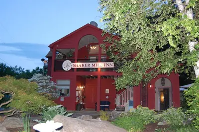 a red building with a sign that reads shaker mill inn at Shaker Mill Inn in West Stockbridge