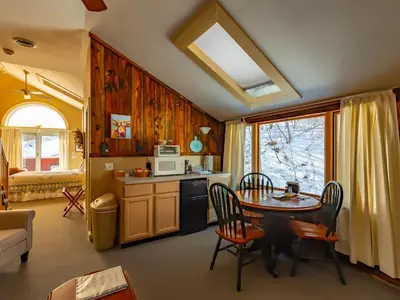 a kitchen with a table and chairs in a room at Shaker Mill Inn in West Stockbridge