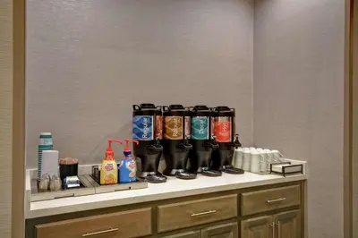 a row of rubber boots on a shelf in a room at Homewood Suites By Hilton Orange New Haven in Orange