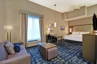 a hotel room with a bed and a desk at Homewood Suites By Hilton Orange New Haven in Orange