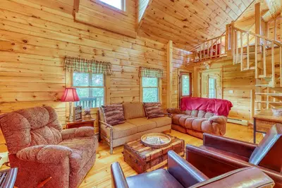 a living room with furniture in a log cabin at Log Cabin Escape in Jacksonville