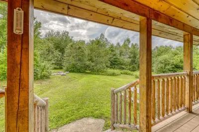 a porch with a view of a yard at Log Cabin Escape in Jacksonville