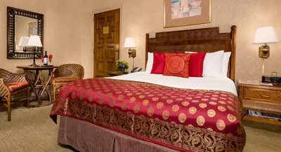 a hotel room with a large bed with red pillows at Casablanca Hotel by Library Hotel Collection in New York