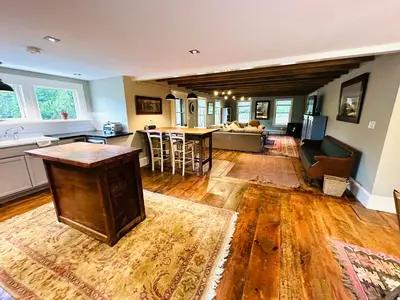 a kitchen and living room with a couch and a table at Mill Pond Inn in Jefferson
