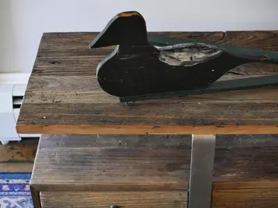 a black bird sitting on top of a wooden table at Mill Pond Inn in Jefferson