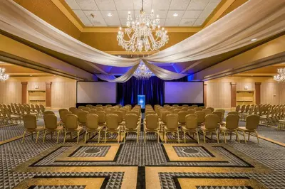 a conference room with chairs and a chandelier at Radisson Lackawanna Station Hotel Scranton in Scranton