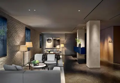 a living room with a couch and a table at Hotel AKA NoMad in New York