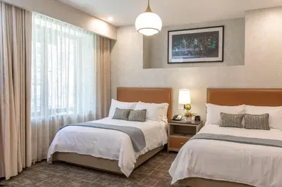 a hotel room with two beds and a window at Broadway Plaza Hotel in New York