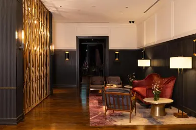 a hallway with a red chair and a table at Kixby in New York