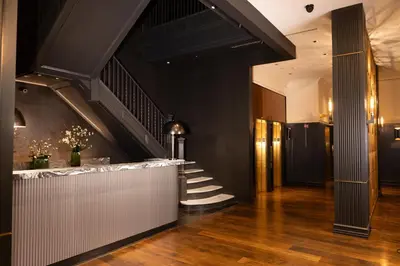 a lobby with a stairway leading to a building at Kixby in New York