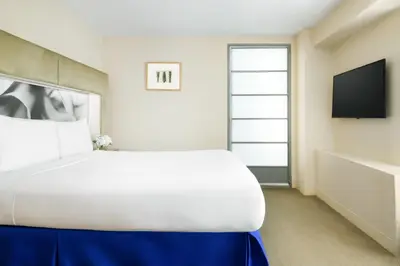a bedroom with a large bed and a flat screen tv at The Shoreham in New York