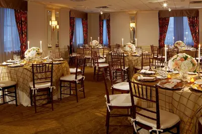 a banquet room with tables and chairs and candles at Warwick New York in New York