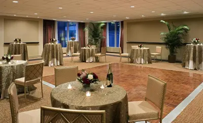 a banquet room with tables and chairs with flowers on them at Millennium Hotel Broadway Times Square in New York