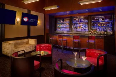 a bar with red chairs and tables in a room at Millennium Hotel Broadway Times Square in New York
