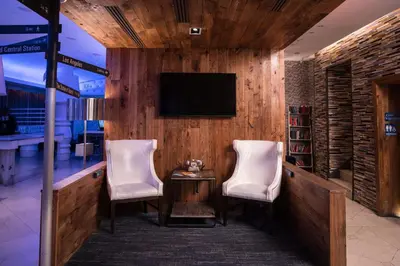 a lobby with two chairs and a television on a wall at The Gallivant Times Square in New York