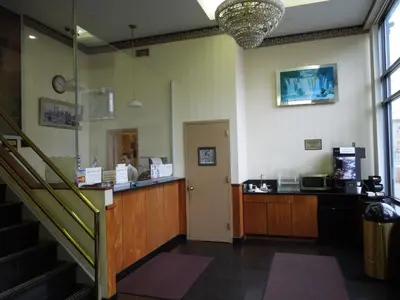 a restaurant with a cashier and a counter in a room at Red Carpet Inn Brooklyn in Brooklyn