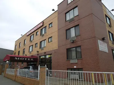 a red brick building with a motel sign on it at Red Carpet Inn Brooklyn in Brooklyn