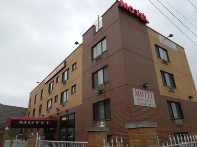 a brick building with a sign on top of it at Red Carpet Inn Brooklyn in Brooklyn